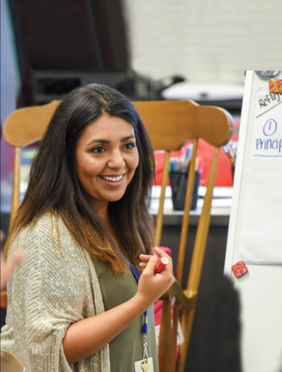 Female student with a white board.
