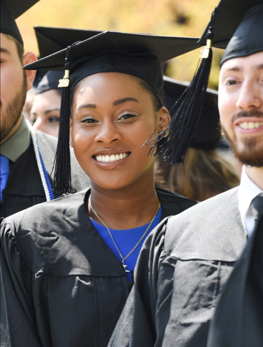 Female graduate wearing a cap and gown.