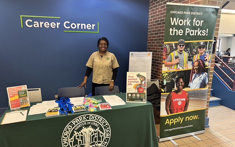 Female Chicago Park District employee at a Career Corner table.